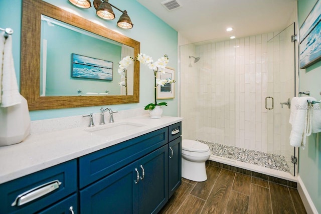 336 Avenida De Mayo, Sarasota, FL 34242 - full bathroom featuring visible vents, toilet, vanity, wood tiled floor, and a stall shower