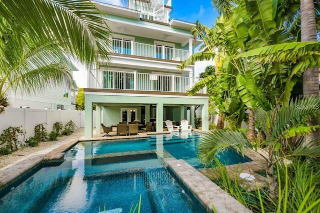 336 Avenida De Mayo, Sarasota, FL 34242 - rear view of property with a pool with connected hot tub, a balcony, fence, and a patio area