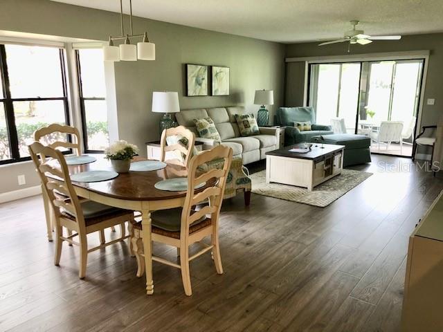 dining room with baseboards, dark wood-style flooring, and ceiling fan