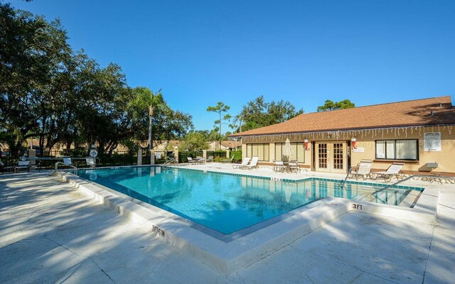 pool with a patio and french doors