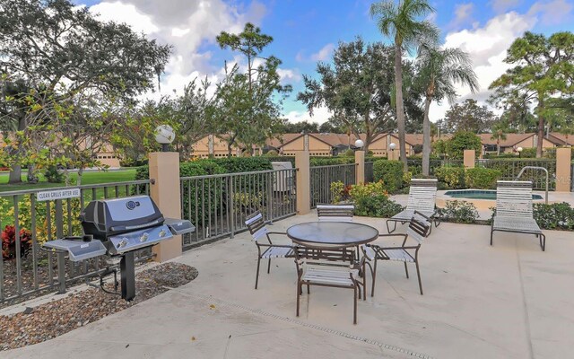 view of patio / terrace featuring fence, a swimming pool, and area for grilling