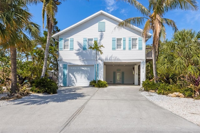 view of front of property featuring a garage, a carport, and driveway