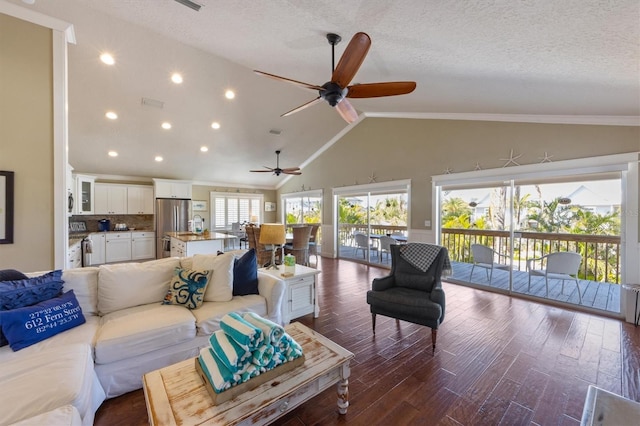 living area with ceiling fan, a textured ceiling, recessed lighting, wood finished floors, and lofted ceiling