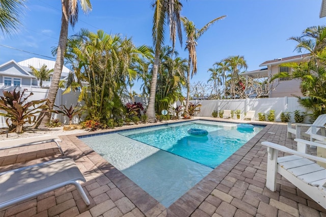 view of pool with a patio, a fenced backyard, and a fenced in pool