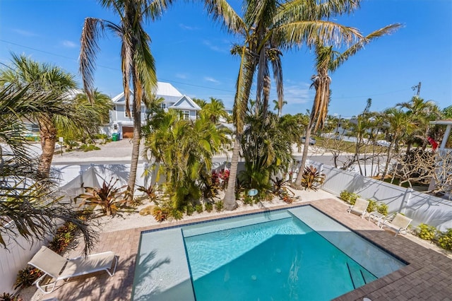 view of swimming pool featuring a patio area, a fenced backyard, and a fenced in pool