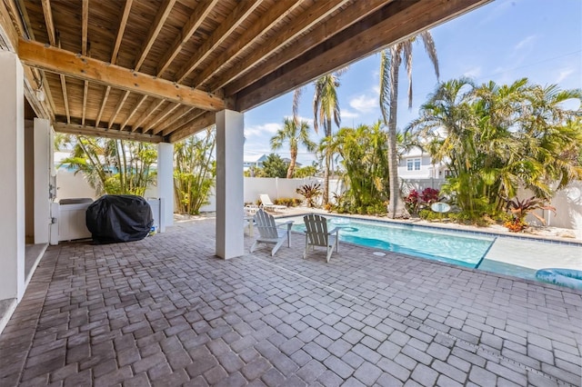 view of patio / terrace with area for grilling, a fenced backyard, and a fenced in pool