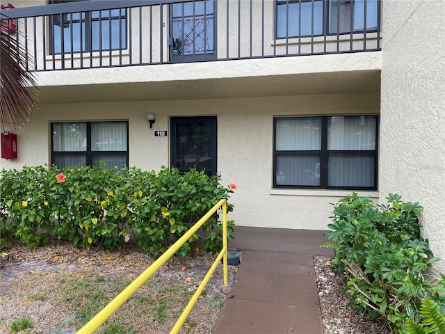 425 30th Ave W Unit C112, Bradenton, FL 34205 - view of exterior entry with stucco siding and a balcony