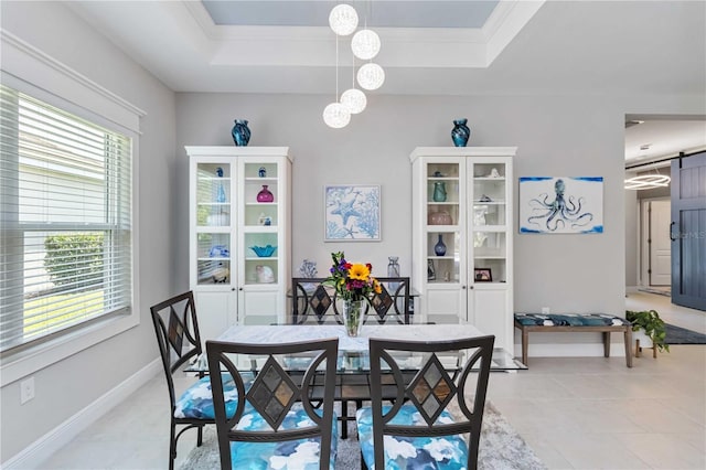 dining room with a tray ceiling, a chandelier, a barn door, light tile patterned floors, and baseboards