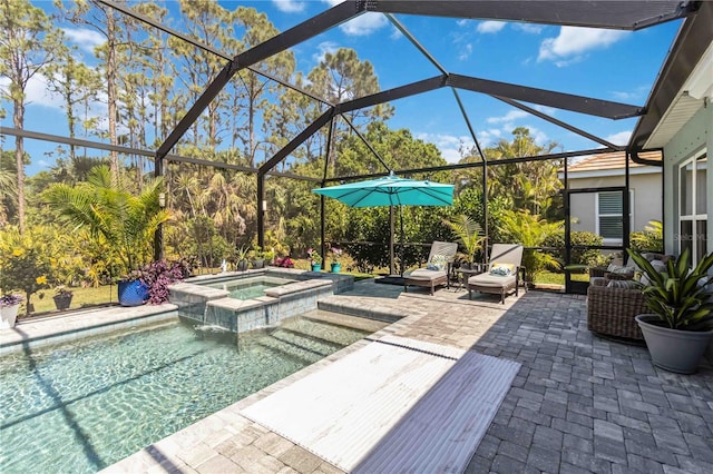 view of patio featuring a lanai and a pool with connected hot tub