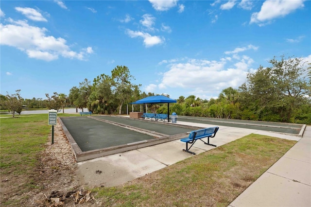surrounding community featuring a bocce ball area and a yard