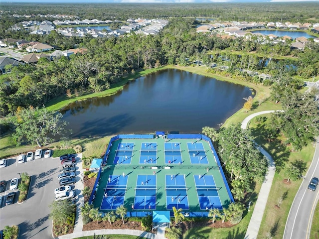 aerial view of property and surrounding area with a nearby body of water and nearby suburban area