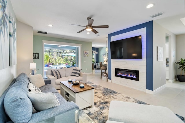 tiled living area with a ceiling fan, a fireplace, recessed lighting, and baseboards