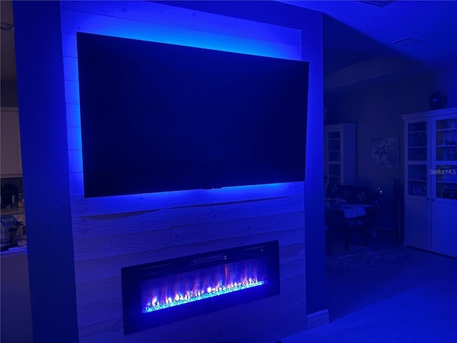 interior space featuring a glass covered fireplace