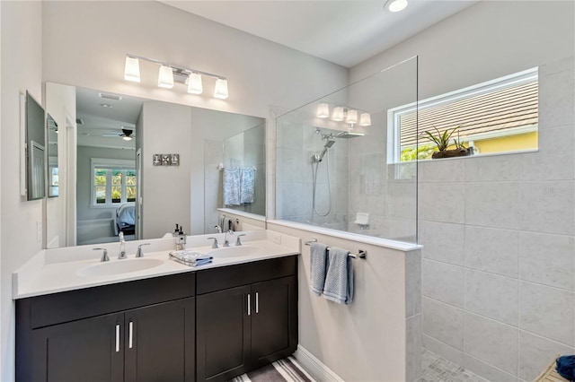 bathroom featuring ensuite bath, walk in shower, double vanity, and ceiling fan