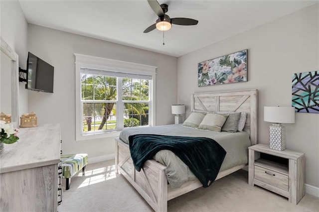bedroom with baseboards, light carpet, and ceiling fan