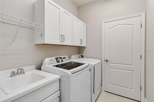 washroom with cabinet space and washing machine and clothes dryer