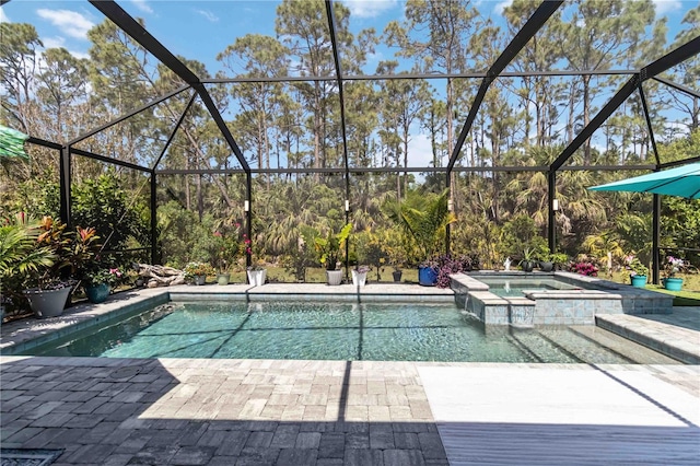 view of pool with a lanai, a pool with connected hot tub, and a patio