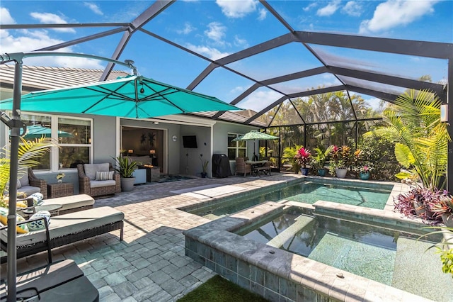 view of swimming pool featuring a patio, a pool with connected hot tub, and glass enclosure