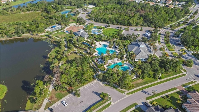 aerial overview of property's location with a nearby body of water and a pool