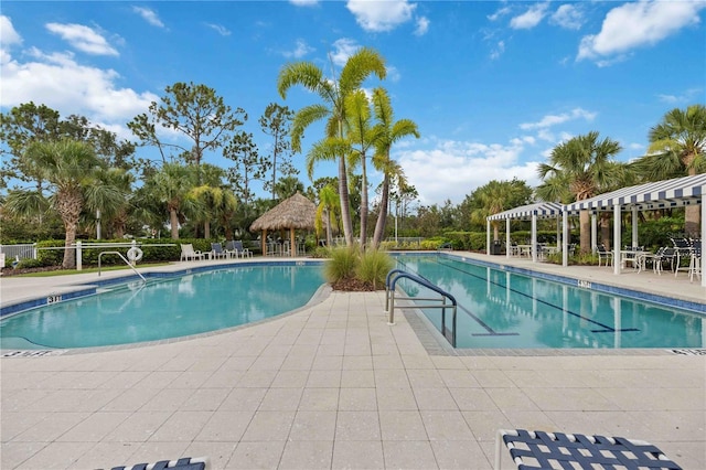 community pool featuring a gazebo, a patio, a pergola, and fence
