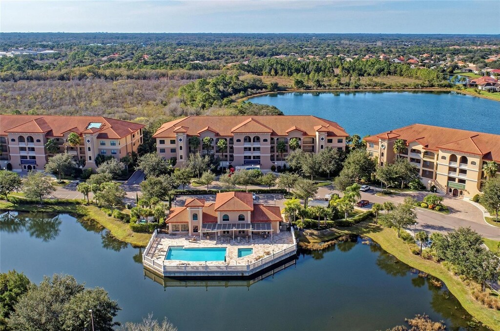 7710 Lake Vista Ct Unit 407, Lakewood Ranch, FL 34202 - birds eye view of property with a water view and a forest view