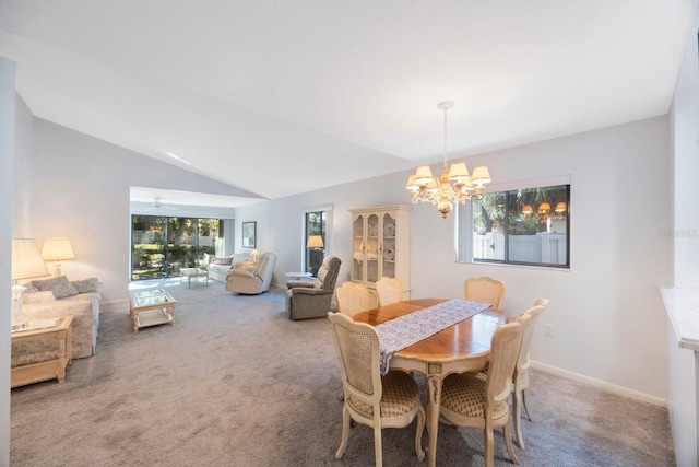 carpeted dining space with a healthy amount of sunlight, an inviting chandelier, baseboards, and lofted ceiling