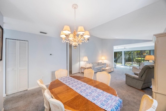 dining space with a chandelier, lofted ceiling, visible vents, and carpet floors