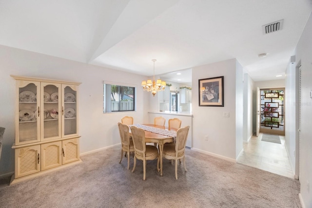 dining space with visible vents, light colored carpet, an inviting chandelier, and baseboards