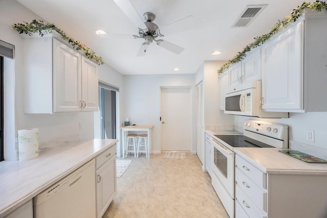 kitchen with white appliances, light countertops, a ceiling fan, white cabinets, and visible vents