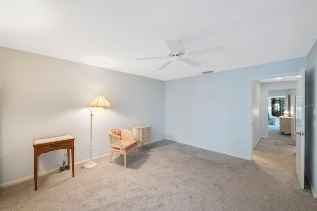 living area featuring baseboards, carpet flooring, ceiling fan, and visible vents