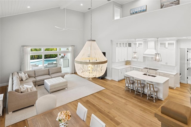 4013 Red Rock Ln, Sarasota, FL 34231 - living area featuring high vaulted ceiling, light wood-type flooring, beam ceiling, a ceiling fan, and baseboards