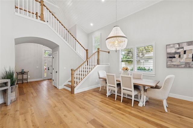 4013 Red Rock Ln, Sarasota, FL 34231 - dining space with high vaulted ceiling, light wood finished floors, arched walkways, stairs, and baseboards