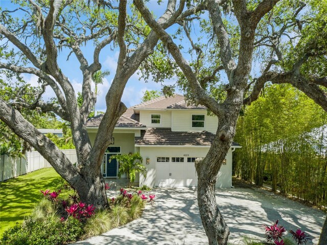 4013 Red Rock Ln, Sarasota, FL 34231 - traditional-style house featuring driveway, stucco siding, a garage, and a tiled roof