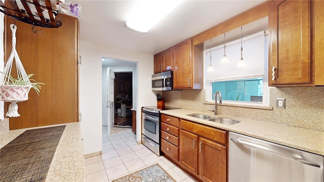5727 25th St W, Bradenton, FL 34207 - kitchen with tasteful backsplash, appliances with stainless steel finishes, a sink, and brown cabinets