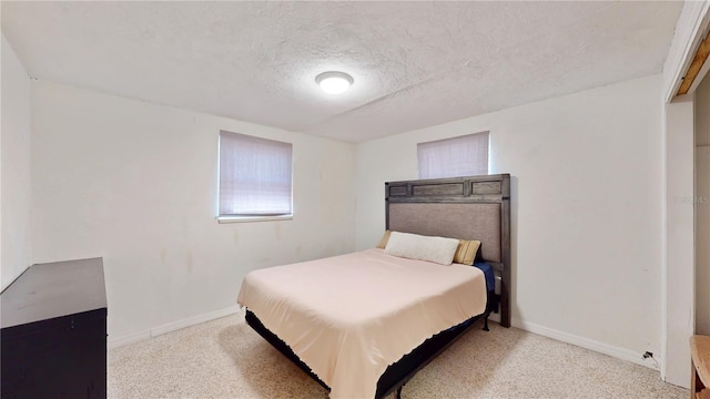5727 25th St W, Bradenton, FL 34207 - carpeted bedroom with a textured ceiling and baseboards