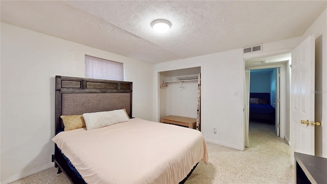 5727 25th St W, Bradenton, FL 34207 - bedroom featuring a closet, baseboards, light carpet, a textured ceiling, and visible vents
