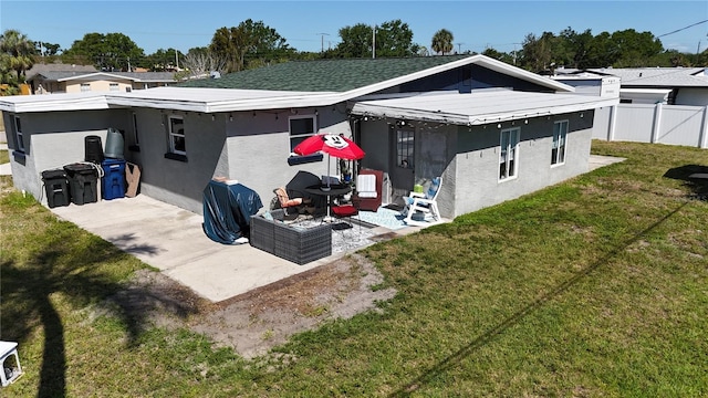 5727 25th St W, Bradenton, FL 34207 - back of house featuring a patio area, stucco siding, fence, and a lawn