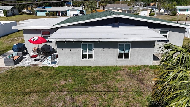 5727 25th St W, Bradenton, FL 34207 - view of property exterior featuring a yard, stucco siding, and fence