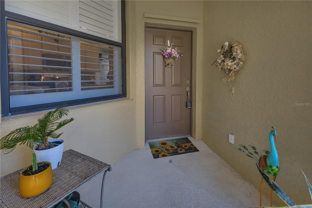 2064 Batello Dr, Venice, FL 34292 - entrance to property featuring stucco siding and covered porch
