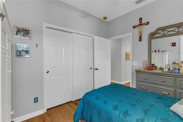 2064 Batello Dr, Venice, FL 34292 - bedroom with wood finished floors, a closet, and baseboards