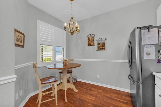 2064 Batello Dr, Venice, FL 34292 - dining room with a chandelier, wood finished floors, and baseboards