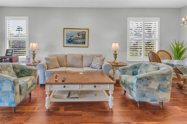 2064 Batello Dr, Venice, FL 34292 - living room featuring plenty of natural light, wood finished floors, and a chandelier