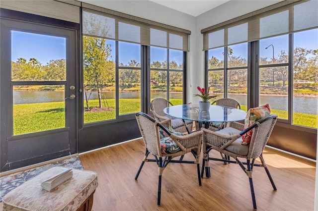 2064 Batello Dr, Venice, FL 34292 - sunroom featuring a water view, wood finished floors, healthy amount of natural light, and outdoor dining space