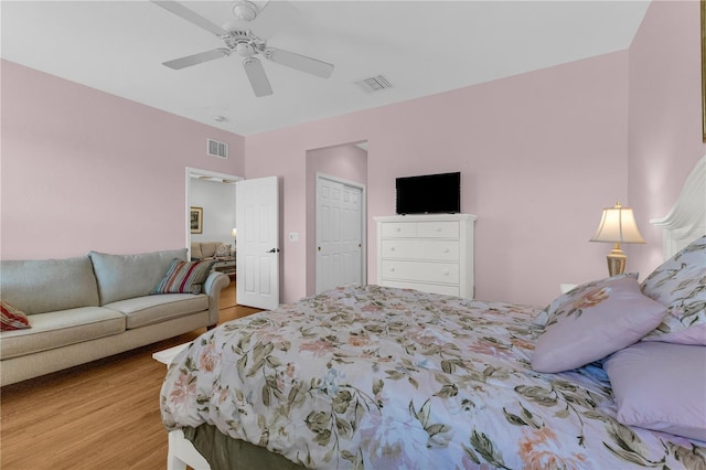 2064 Batello Dr, Venice, FL 34292 - bedroom with wood finished floors, ceiling fan, and a closet