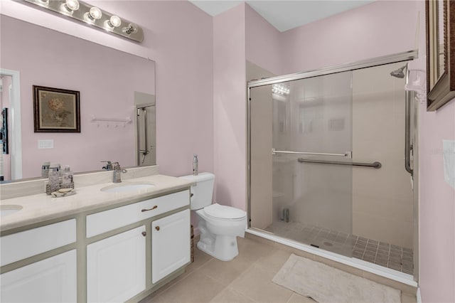 2064 Batello Dr, Venice, FL 34292 - full bathroom with toilet, a shower stall, double vanity, and tile patterned floors