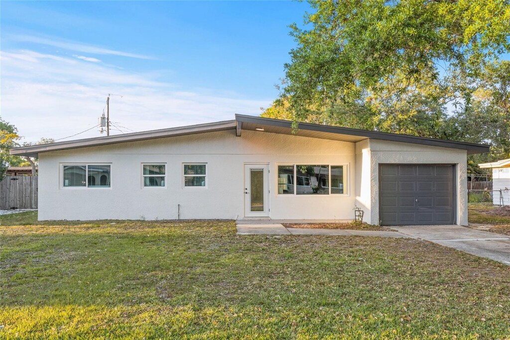 3169 Bellevue St, Sarasota, FL 34237 - single story home with stucco siding, driveway, a front yard, and a garage
