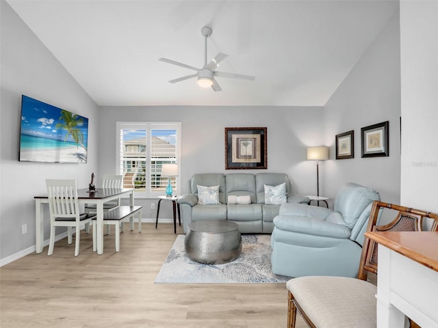 21687/689 Indian Bayou Dr, Fort Myers Beach, FL 33931 - living room with baseboards, a ceiling fan, vaulted ceiling, and light wood-type flooring