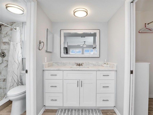 21687/689 Indian Bayou Dr, Fort Myers Beach, FL 33931 - bathroom featuring a stall shower, toilet, vanity, wood finished floors, and ceiling fan