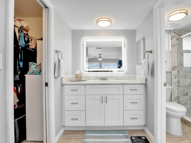 21687/689 Indian Bayou Dr, Fort Myers Beach, FL 33931 - bathroom with visible vents, toilet, a ceiling fan, tiled shower, and vanity