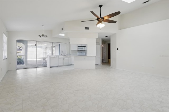 23116 Amethyst Ave, Port Charlotte, FL 33952 - unfurnished living room with visible vents, baseboards, ceiling fan with notable chandelier, and high vaulted ceiling